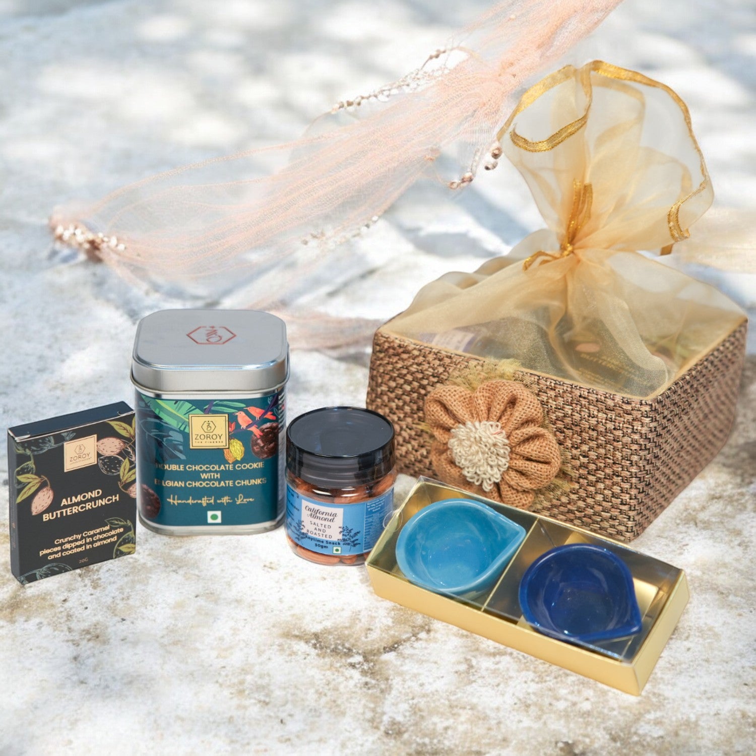 ZOROY Jute Essential Hamper – Stylish Resuable Jute Gift Basket containing Chocolates , 2 Ceramic Diyas, Handcrafted Cookies, Assorted Chocolates,  Californian Almonds – Ideal Gift Set for Special Occasions, Diwali Gifting