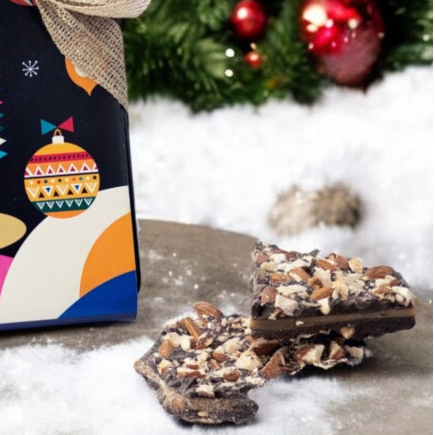 ZOROY Christmas Message Almond Buttercrunch Tin (crisp caramelized center coated with dark chocolates & almonds) - 150 gms