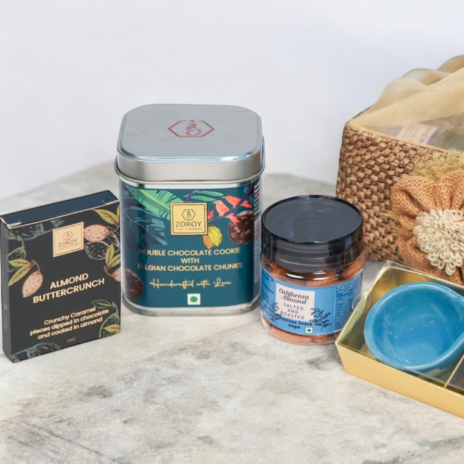 ZOROY Jute Essential Hamper – Stylish Resuable Jute Gift Basket containing Chocolates , 2 Ceramic Diyas, Handcrafted Cookies, Assorted Chocolates,  Californian Almonds – Ideal Gift Set for Special Occasions, Diwali Gifting
