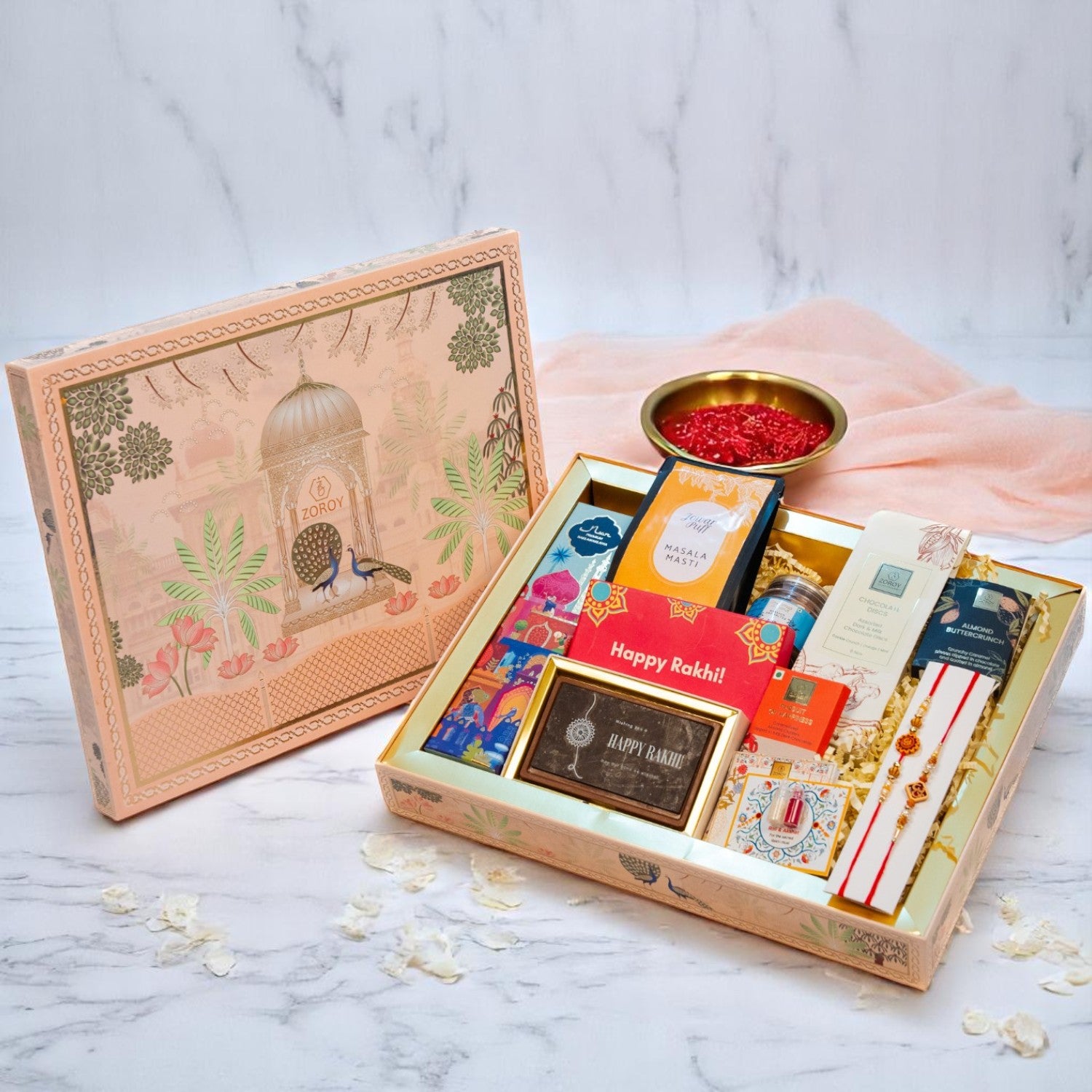 ZOROY Madhubani Rakhi Gift Hamper | Premium Noor Baklawa, Snacks, Almonds, Berries, Chocolates, Buttercrunch, 2 Rakhis, Printed Chocolate Box, Akshat Kumkum & Rakhi Card | Raksha Bandhan Gift