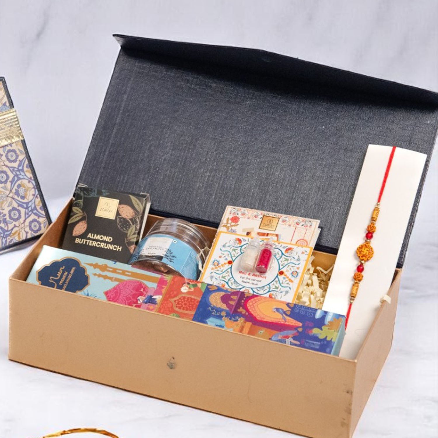ZOROY Neel Rakhi Hamper with 4 Premium Noor Baklava, 50g Salted Almonds, Buttercrunch Snacks, Designer Rakhi, Akshat Kumkum Pack & Rakhi Card – Traditional Raksha Bandhan Gift Set