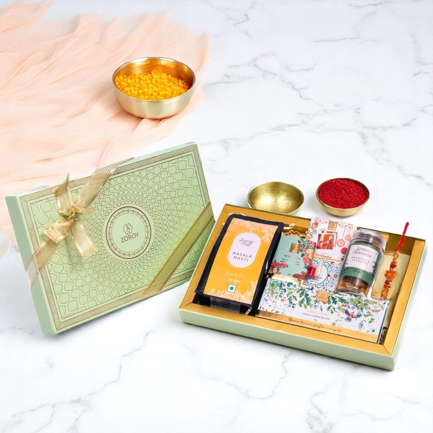 ZOROY Elegant Peacock Rakhi Gift Box | Snack Pack, Almond Buttercrunch, Chocolate-Dipped Fairy Tale Biscuits, Raisins 100g, Rakhi, Akshat Kumkum & Greeting Card | Raksha Bandhan Gift for Brother & Sister
