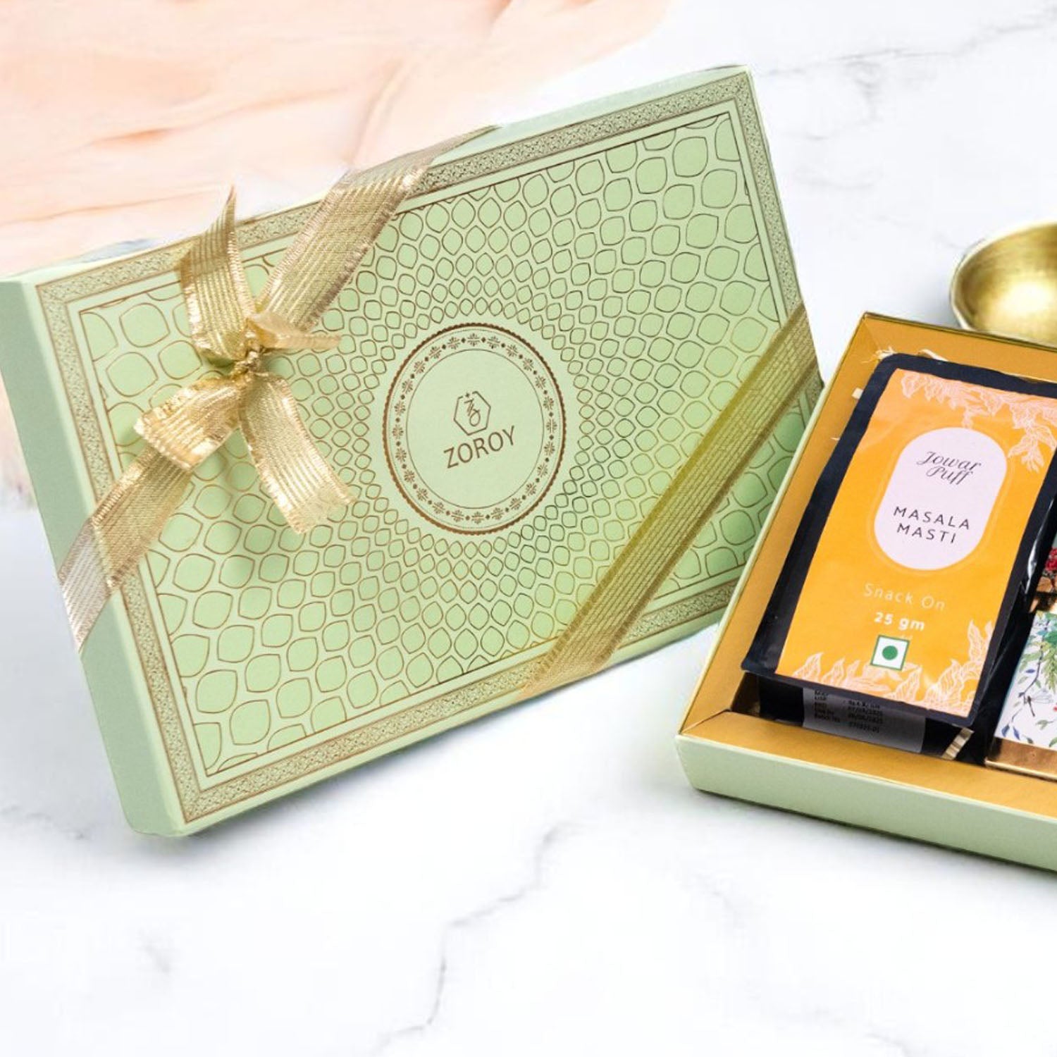 ZOROY Elegant Peacock Rakhi Gift Box | Snack Pack, Almond Buttercrunch, Chocolate-Dipped Fairy Tale Biscuits, Raisins 100g, Rakhi, Akshat Kumkum & Greeting Card | Raksha Bandhan Gift for Brother & Sister