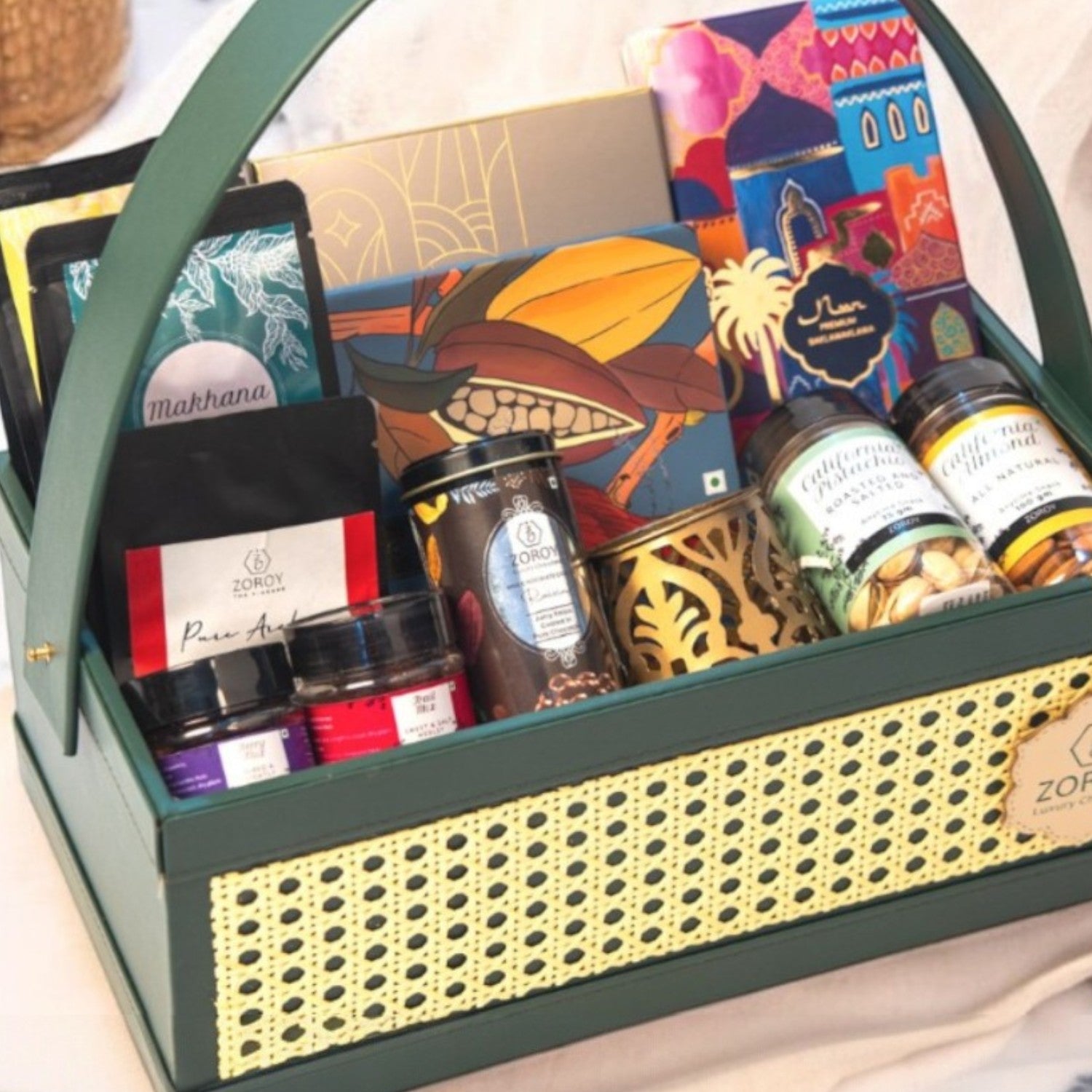 ZOROY green Luxe Rattan Hamper with Chocolates, Dry Fruits, Turkish Baklawa, Metal festive votive, arabica coffee,, mixed berries, snack packs. Perfect for everyday and festive gifting