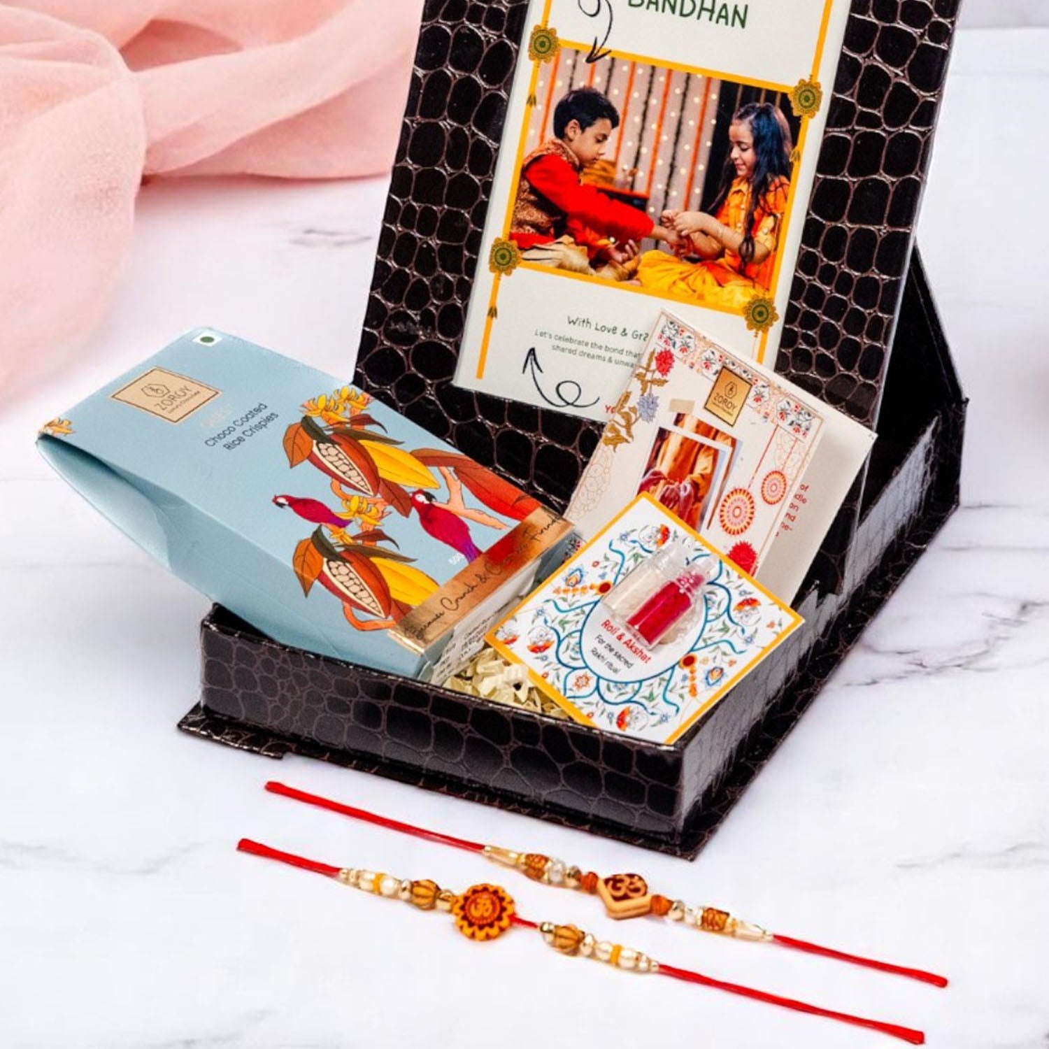 ZOROY Personalized Rakhi Photo Box Hamper – Custom Upload Picture Keepsake Rakhi Gift Box with Choco Coated Rice Crisps, 2 Rakhis, Akshat Kumkum, Rakhi Card | Raksha Bandhan Gifts for Brother